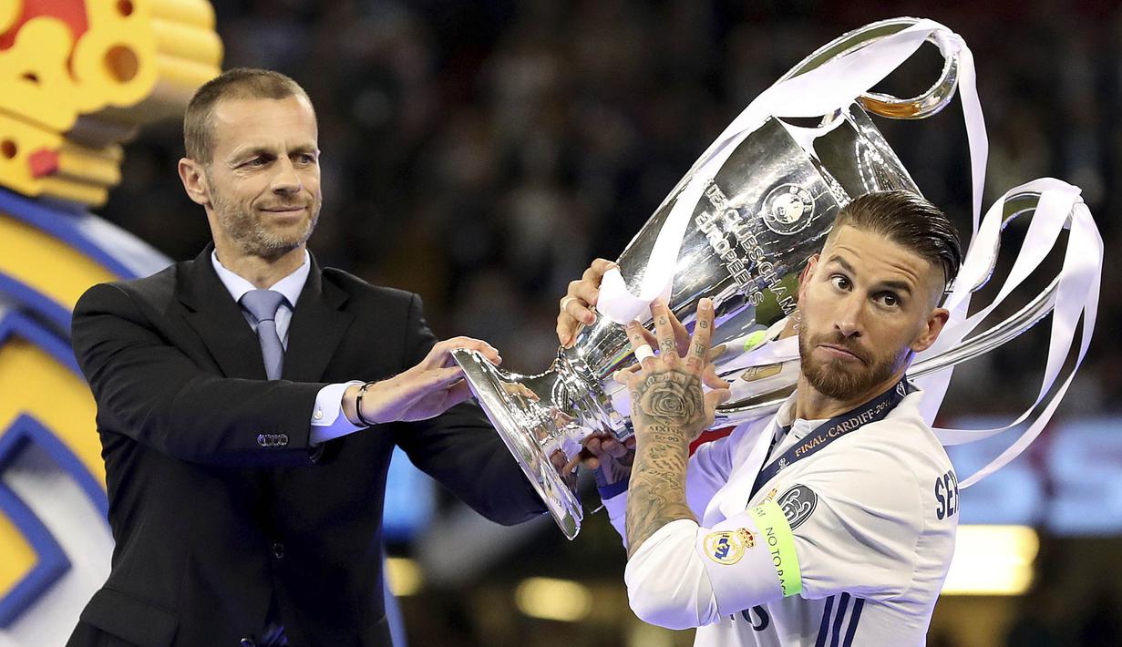 Presiden UEFA, Aleksander Ceferin, memeberikan piala Liga Champion kepada Kapten Real Madrid, Sergio Ramos di Stadion Millennium, Cardiff, (03/06/2017). (AP/Nick Potts)