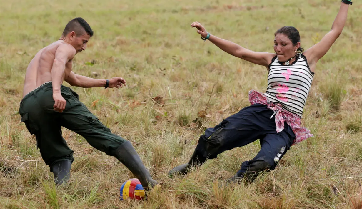 Pejuang dari Angkatan Bersenjata Revolusioner Kolombia (FARC) bermain sepak bola di sebuah kamp di mana mereka mempersiapkan diri untuk meratifikasi kesepakatan damai dengan pemerintah, di Yari Plains, Kolombia, (19/9). (REUTERS/John Vizcaino)