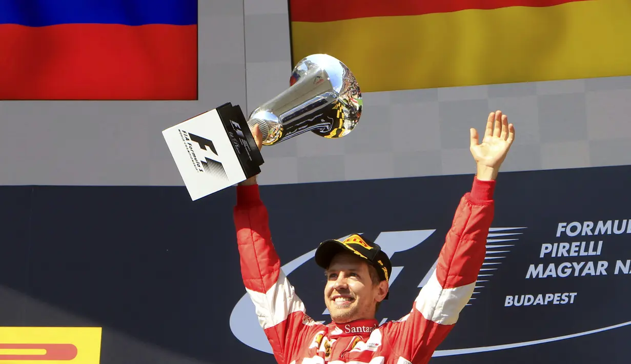 Sebastian Vettel dengan trofi juara. (REUTERS/Bernadett Szabo)
