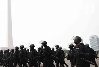 Personel Korps Brimob Polri berjalan untuk mengikuti apel gabungan gelar pasukan di Silang Monas, Jakarta, Senin (11/4/2022). Polda Metro Jaya mengerahkan sebanyak 5.620 pasukan gabungan Polri-TNI dalam rangka pengamanan aksi unjuk rasa BEM SI. (Liputan6.com/Herman Zakharia)