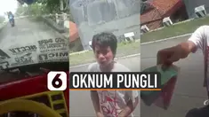 Terlihat seorang pria memberhentikan laju truk dan meminta sejumlah uang kepada sopir.