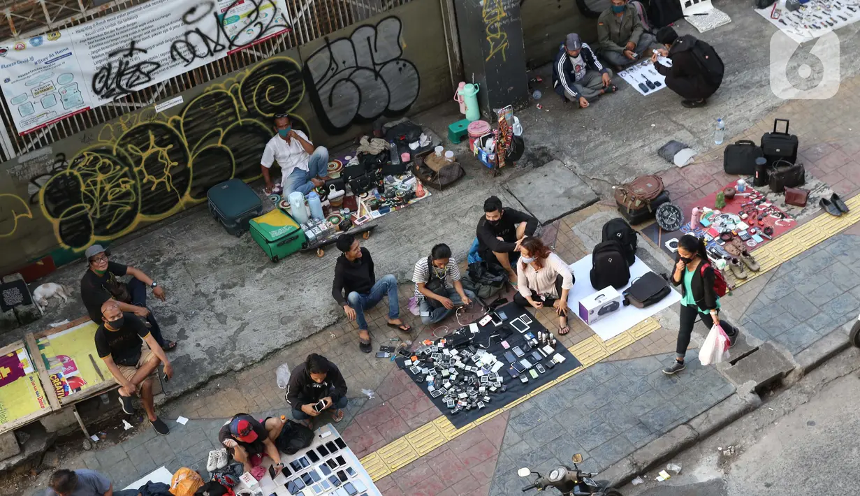 Pedagang kaki lima menjajakan dagangannya di trotoar kawasan Kebayoran Lama, Jakarta, Jumat (15/5/2020). Kondisi ini menyulitkan pejalan kaki yang akan melintasi trotoar di kawasan tersebut. (Liputan6.com/Helmi Fithriansyah)
