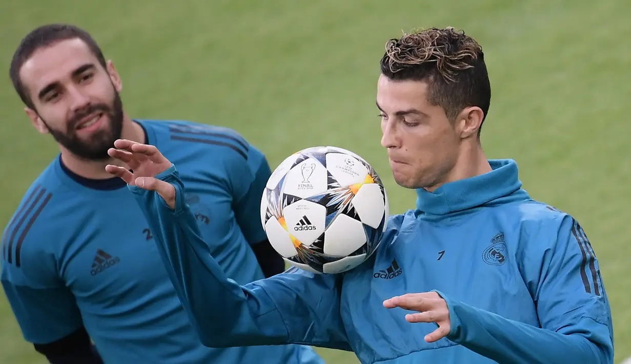 Pemain Real Madrid, Cristiano Ronaldo menahan bola dengan pundaknya saat sesi latihan di Allianz Stadium, Turin, Italia, Senin (2/4). Real Madrid akan menghadapi Juventus pada laga perempat final Liga Champions. (AFP PHOTO/Marco BERTORELLO)