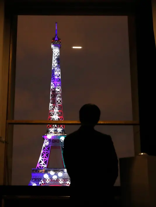 Putra Mahkota Jepang, Naruhito melihat ke arah Menara Eiffel yang berhias cahaya warna-warni di Paris, Perancis, Kamis (13/9). Pertunjukan ini dipersembahkan oleh seniman Jepang, Motoko Ishii. (AP Photo/Christophe Ena)