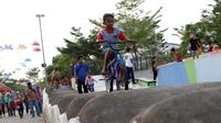 Seorang anak bermain sepeda di area Skate Park RPTRA Kalijodo, Jakarta, Sabtu (15/6/2019). Menjelang sore hari, anak-anak berdatangan menghabiskan waktu dengan bermain di area RPTRA Kalijodo. (Liputan6.com/Helmi Fithriansyah)