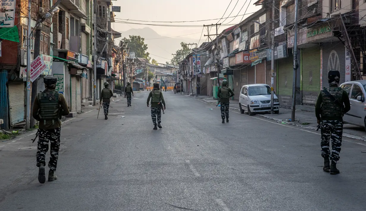 Paramiliter bersenjata melakukan patroli di jalan yang dikosongkan di Srinagar, Kashmir yang dikuasai India, Rabu (5/8/2020). Tentara India memperketat keamanan di Kashmir dalam upaya menahan serangan dalam peringatan setahun pelepasan status otonomi khusus wilayah tersebut. (AP Photo/ Dar Yasin)
