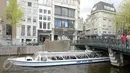 Warga menaiki perahu saat melintasi kanal di kawasan Amsterdam, Belanda (April 2017). Meskipun pada abad ke-19 kotor dan dipenuhi limbah, kini kanal-kanal di Belanda menjadi salah satu objek wisata terkenal di dunia. (Liputan6.com/Immanuel Antonius)