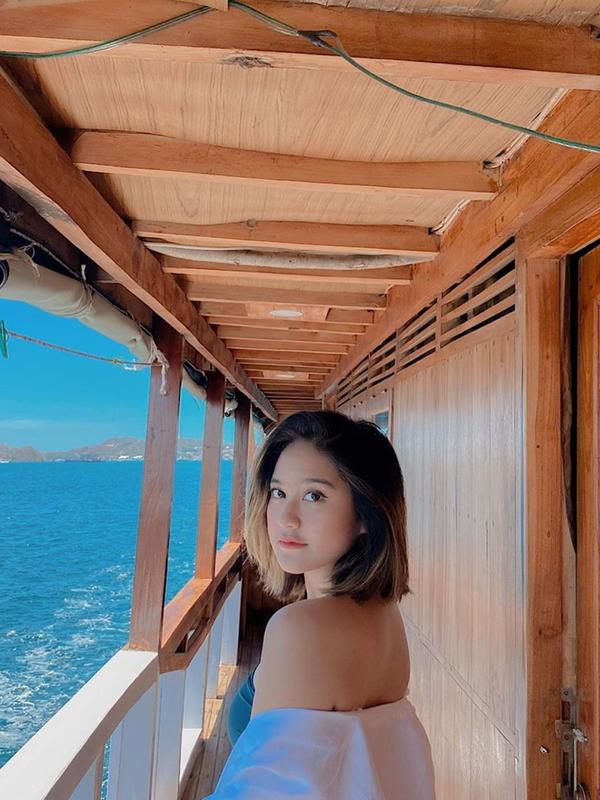 Dengan mengenakan busana putih dan topi, Salshabilla Adriani pun nampak memesona. Apalagi kini ia juga punya penampilan baru. Yaitu dengan rambut pendeknya yang sebelumnya selalu panjang. Pemandangan yang indah pun terlihat indah disaksikan dari atas kapal. (Liputan6.com/IG/@salshabillaadr)