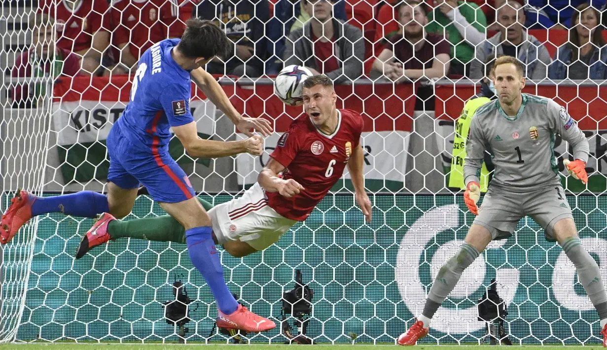 Pemain Hungaria Willi Orban (tengah) menghalau tembakan pemain Inggris Harry Maguire (kiri) pada pertandingan sepak bola Grup I kualifikasi Piala Dunia 2022 di Puskas Ferenc Arena, Budapest, Hungaria, Kamis (2/9/2021). Inggris menang 4-0. (Zsolt Szigetvary/MTI via AP)
