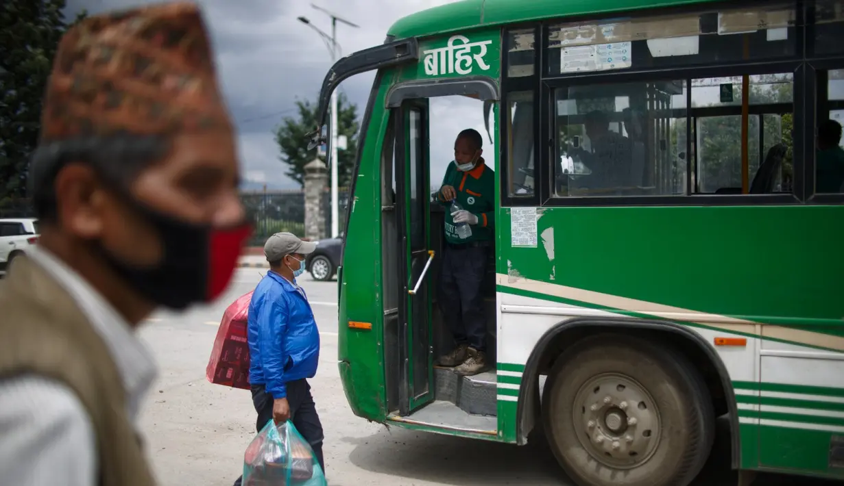 Calon penumpang bersiap naik bus di Kathmandu, Nepal (16/7/2020). Beberapa perusahaan angkutan umum di Lembah Kathmandu sudah mulai mengoperasikan kembali rute mereka untuk pertama kalinya dalam hampir empat bulan setelah menerima persyaratan operasional dari pemerintah. (Xinhua/Sulav Shrestha)