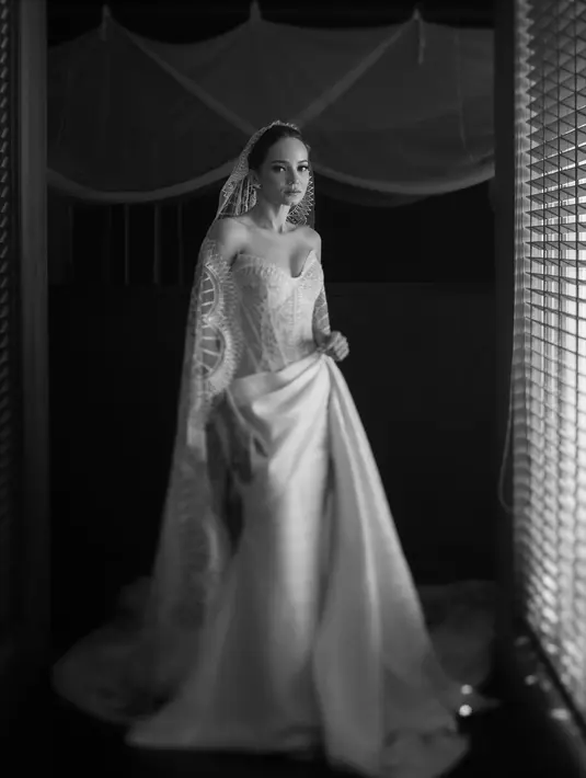 Dengan desain tube dress dan detail slit bikin aura pengantin Enzy semakin keluar.  [@monicaivena].