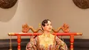 Andien tampil mengenakan kebaya brokat kuning dipadukan outer berupa bra top dan lengan balon, serta rok merah motif batik. [@hagaipakan]