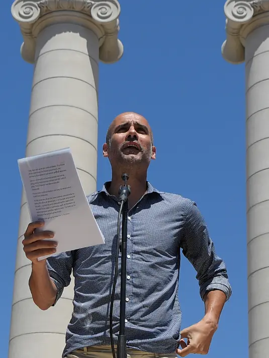 Pelatih Manchester City Pep Guardiola membacakan sikap politiknya di Barcelona, Minggu (11/6). Pep Guardiola memberikan pernyataan politik yang meminta Pemerintah Spanyol memberikan kemerdekaan kepada Catalan melalui referendum. (LLUIS GENE/AFP)