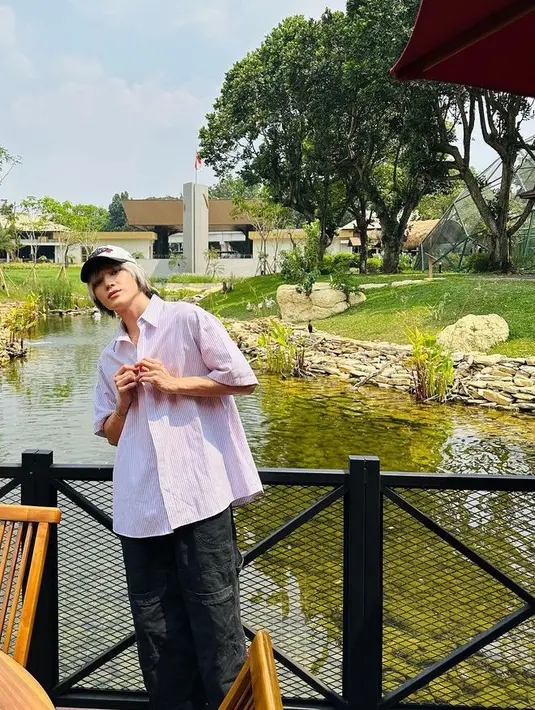 Taeyong juga mengenakan kemeja oversize lengan pendek bergaris, dipadukan celana hitamnya. [@taeoxo_nct]