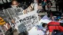 Warga menandatangani kain putih sebagai dukungan saat aksi 'Kami Sayang Badak' pada Car Free Day di kawasan Bunderan HI, Jakarta, (27/3). Aksi tersebut guna Memperingati hari bumi dan kampanye Badak yang hampir punah. (Liputan6.com/Faizal Fanani)