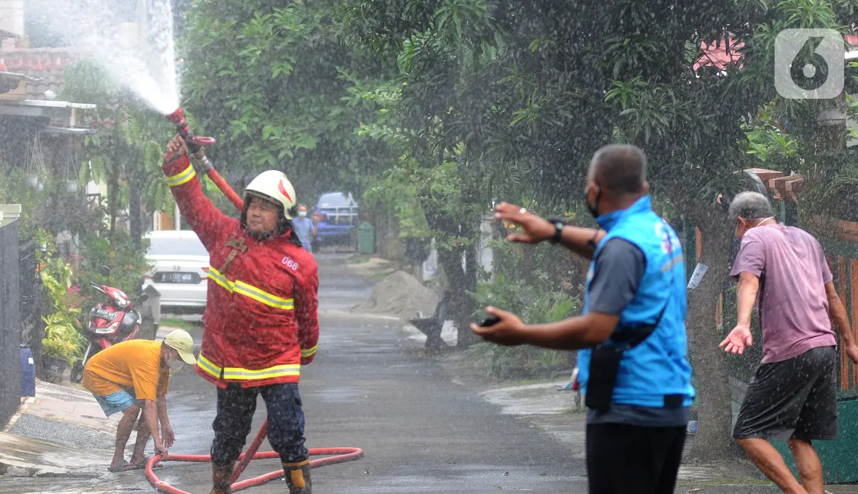 Petugas Damkar menyemprotkan cairan disinfektan pada pemukiman RW 21 Keluarahan Benda Baru, Tangerang Selatan, Banten, Kamis (1/7/2021). Penyemprotan dilakukan pada kawasan zona merah dimana di wialayah ini 46 warga terpapar Covid-19. (merdeka.com/Arie Basuki)