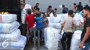 Pekerja memasukkan karung ke dalam mobil untuk didistribusikan ke seluruh daerah di Indonesia, Jakarta, Jumat (27/5). Melonjaknya permintaan pakaian jelang puasa menjadi berkah bagi para pedagang. (Liputan6.com/Angga Yuniar)