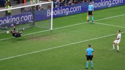 Kiper Portugal, Diogo Costa (kiri) mementahkan tendangan pemain Slovenia, Jure Balkovec pada babak adu penalti saat babak 16 besar Euro 2024 di Frankfurt Arena, Frankfurt, Jerman, Senin (02/07/2024) WIB. (AFP/Daniel Roland)