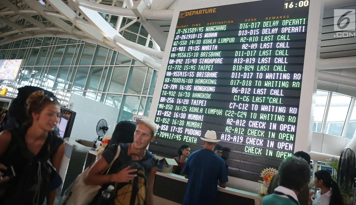 Layar daftar penerbangan terlihat di Terminal Internasional Bandara I Gusti Ngurah Rai, Bali, Kamis (30/11). Bandara tersebut kembali beroperasi terhitung pukul 15.00 WITA, Rabu (29/11). (Liputan6.com/Immanuel Antonius)