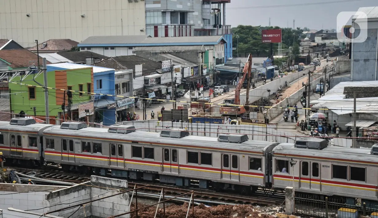 Rangkaian kereta commuterline saat melintasi proyek pembangunan lintas bawah atau underpass di Jalan Dewi Sartika, Depok, Jawa Barat, Minggu (27/11/2022). Proyek pembangunan underpass yang melintang dari arah Dewi Sartika ke Jalan Margonda Raya itu terus dikebut dan saat ini sudah mencapai 75 persen. (merdeka.com/Iqbal S. Nugroho)