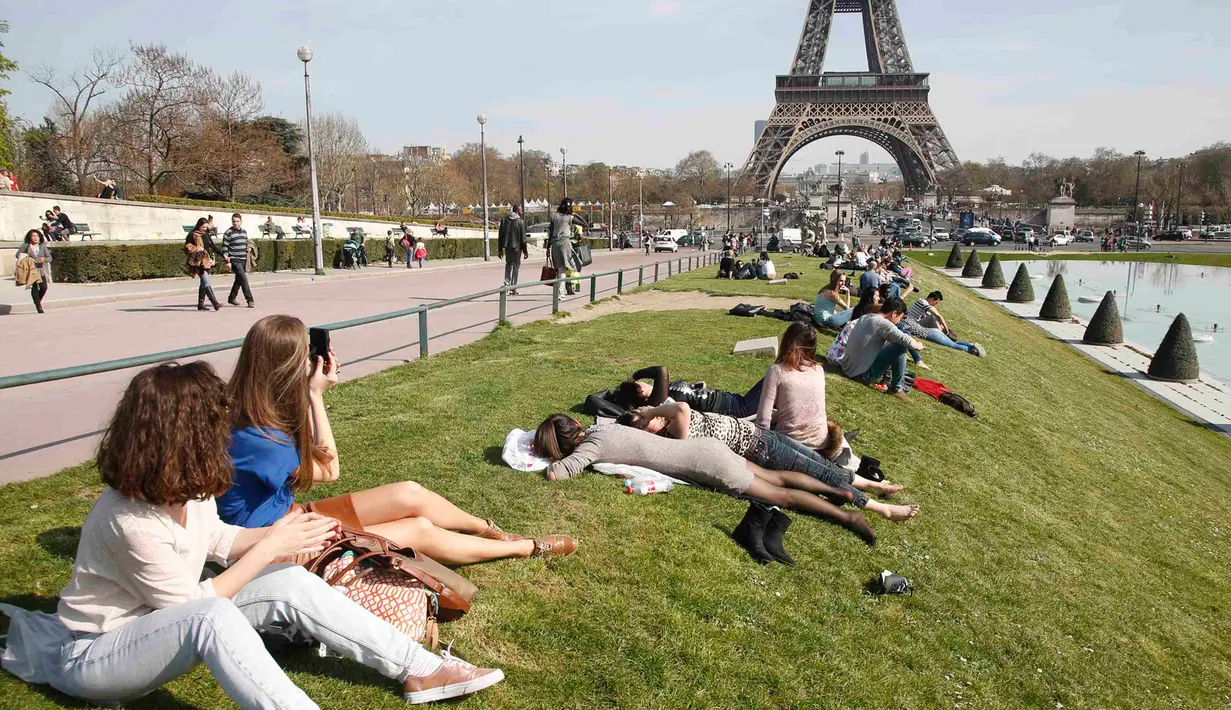 Wisatawan menikmati musim semi yang hangat dan cerah di Trocadero square di dekat menara Eiffel, Paris, Kamis (9/4/2015). (REUTERS/Charles Platiau)