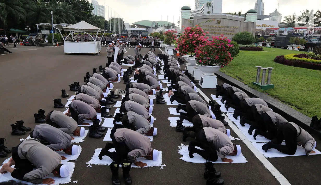 Pasukan Dzikir Asmaul Husna melakukan sujud saat salat di Gedung MPR/DPR, Senayan, Jakarta, Selasa (24/10). Sebanyak 299 personel dikerahkan untuk menjaga demo menolak Perppu Ormas di gedung DPR. (Liputan6.com/JohanTallo)