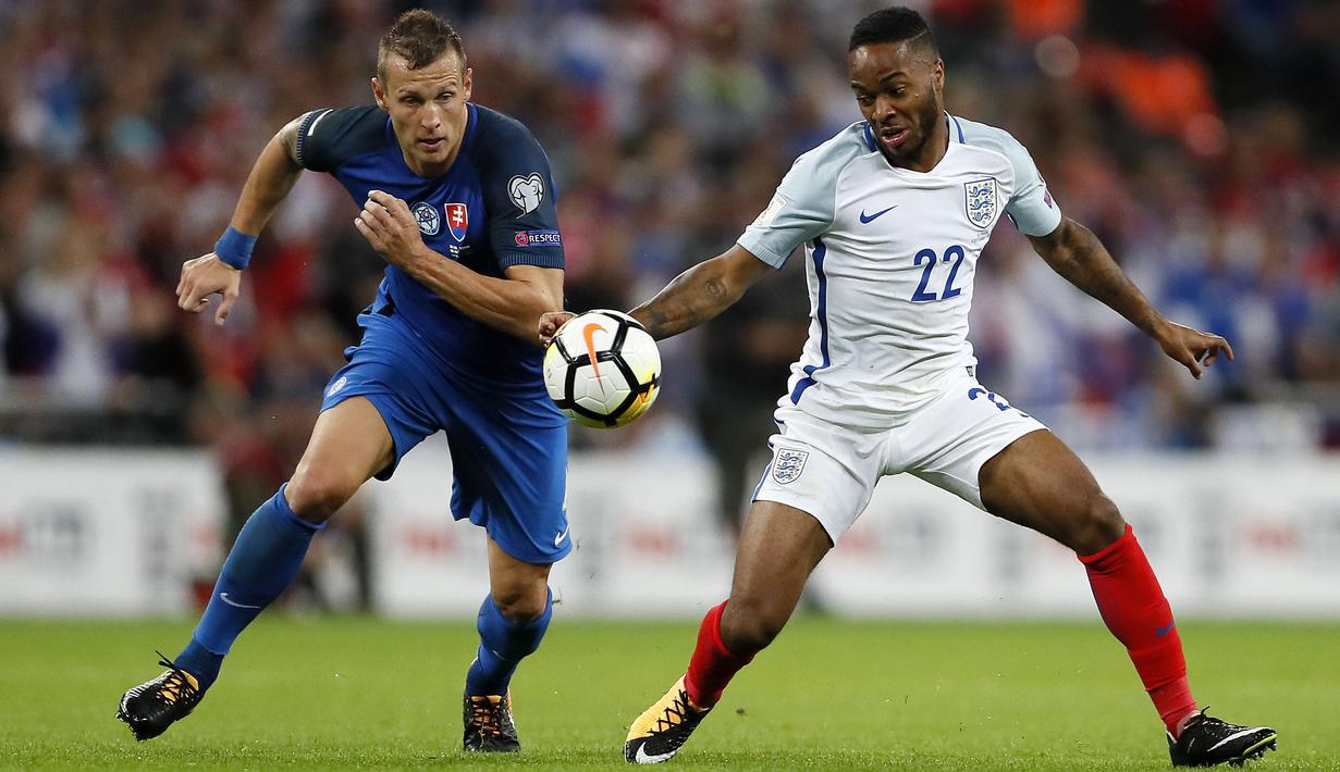 Pemain Inggris, Raheem Sterling (kanan) berusaha melewati adangan pemain Slovakia, Jan Durica pada laga grup F kualifikasi Piala Dunia 2018 di Wembley stadium, London, (4/9/2017). Inggris menang 2-1. (AP/Kirsty Wigglesworth)