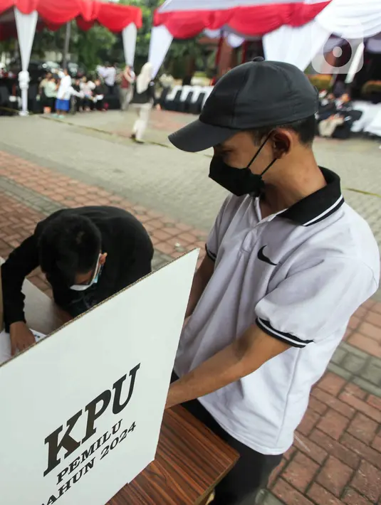 Warga melakukan pencoblosan surat suata dalam bilik saat simulasi pemungutan suara Pemilu 2024 di Halaman Kantor Wali Kota Jakarta Pusat, Rabu (17/1/2024). (Liputan6.com/Herman Zakharia)