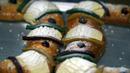 Gula ditaburkan pada kue-kue tradisional Rosca de Reyes di toko roti Chef Francisco Vasquez sehari sebelum Epiphany atau Hari Tiga Raja, Mexico City, Meksiko, 5 Januari 2022. (AP Photo/Fernando Llano)