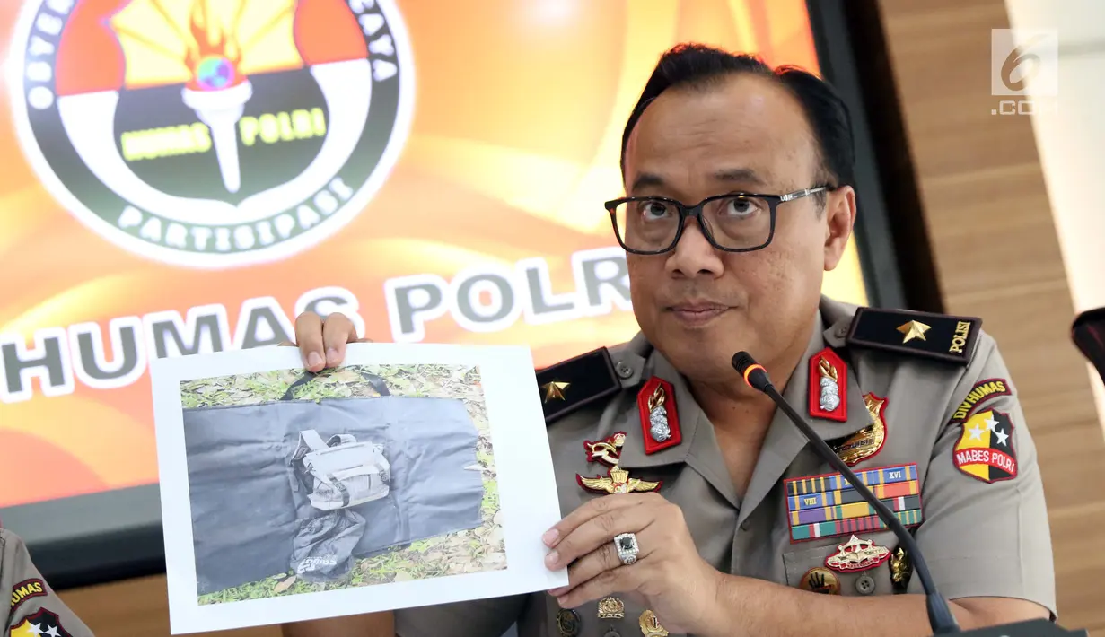 Karopenmas Mabes Polri, Brigjen Dedi Prasetyo menunjukkan gambar tas yang digunakan terduga teroris saat rilis di Jakarta, Senin (6/5/2019). Sebelumnya, Densus 88/Anti Teror meringkus tujuh orang kelompok JAD jaringan Lampung dan menyita sejumlah barang bukti. (Liputan6.com/Helmi Fithriansyah)