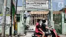 Pengendara sepeda motor saat melintasi pembangunan gedung di yayasan Pergunas I di Jalan Cempaka Baru I, RT 015/003, Kemayoran, Jakarta, Senin (31/8/2020). Pembangunan itu menutup akses jalur keluar masuk rumah warga dan memaksanya harus melewati pintu samping. (merdeka.com/Iqbal S Nugroho)