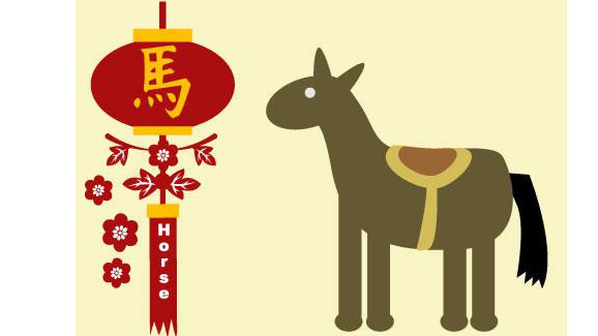  The image shows a brown horse with a red and yellow saddle standing next to a red lantern with the Chinese character for 'horse' written on it.