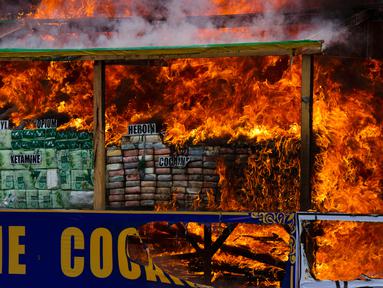 Aparat Myamnar membakar narkotika sitaan dalam acara pemusnahan yang menandai Hari Antinarkoba Sedunia, di Yangon, Senin (26/6). Myanmar membakar opium, heroin, dan kokain senilai sekitar US$385 juta, setara Rp5,1 miliar. (AP Photo/Thein Zaw)