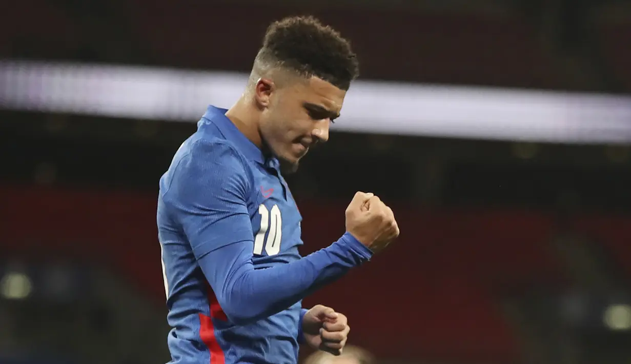 Striker Inggris, Jadon Sancho, merayakan gol yang dicetaknya dalam laga uji coba internasional melawan Republik Irlandia di Stadion Wembley, London, Jumat (13/11/2020) dini hari WIB. Inggris menang 3-0 atas Republik Irlandia. (AP/Nick Potts/Pool)