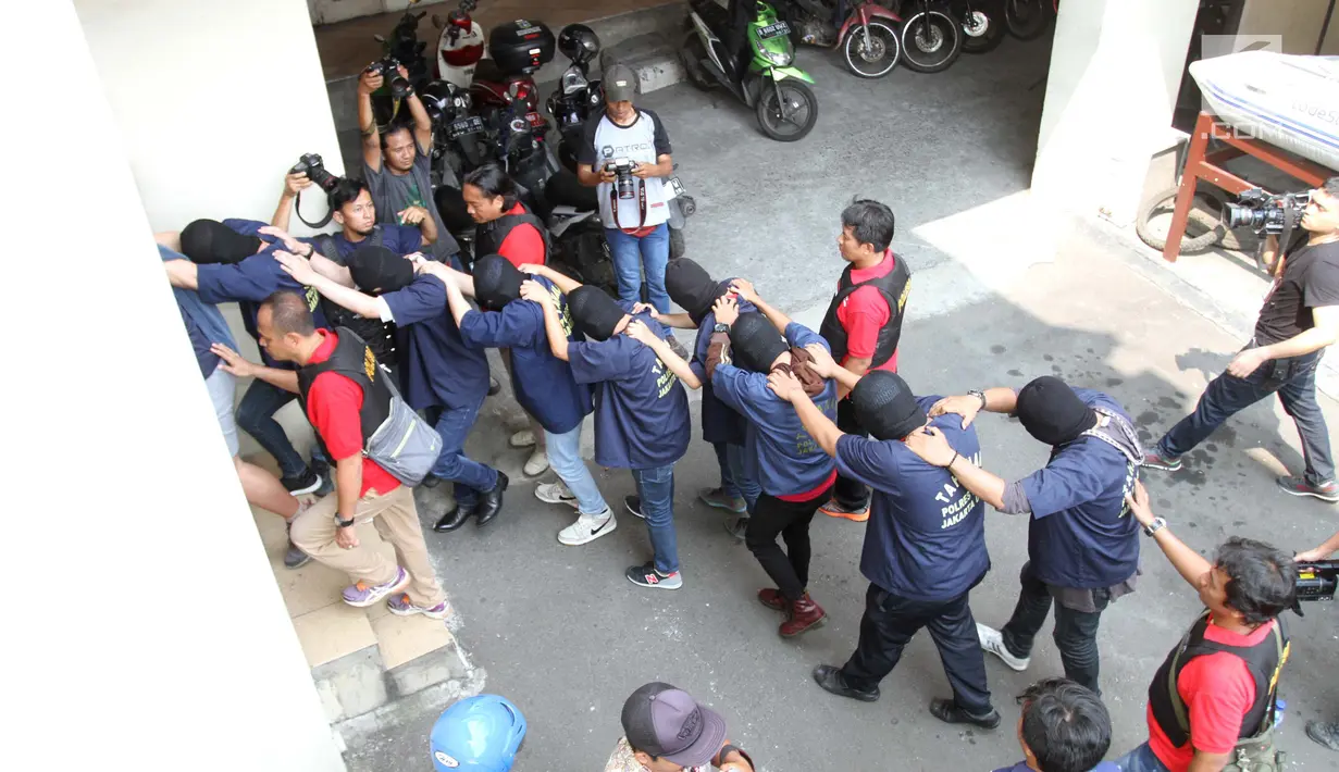 Sejumlah orang yang ditangkap saat penggerebekan PT. Atlantis Jaya di Ruko Kokan Permata Blok B 15-16 Kelapa Gading Rt15/RW 03 Kelapa Gading Barat, Jakarta, Senin (22/5). (Liputan6.com/Gempur M Surya)
