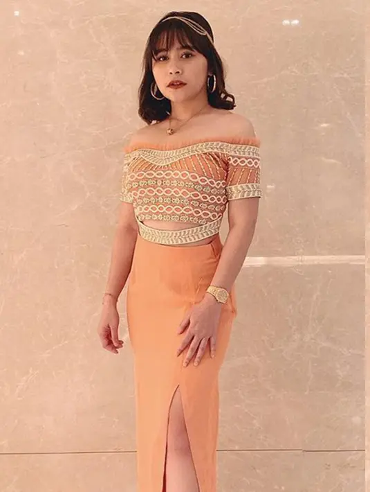 Prilly Latuconsina menarik perhatian dengan balutan crop top yang dipadukan dengan rok berwarna cerah. Ia pun memakai aksesoris headpiece dan kalung berwarna emas. (Liputan6.com/IG/@prillylatuconsina96)