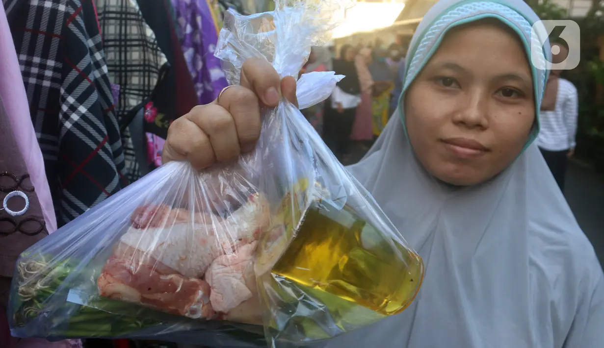 Seorang warga menunjukkan bungkusan plastik berisi bahan makanan. (merdeka.com/Arie Basuki)