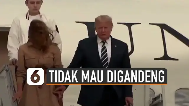 Beredar video Istri Donald Trump tidak mau digandeng oleh suaminya sendiri saat menuruni tangga pesawat Air Force One.