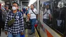 Penumpang Kereta Api Jarak Jauh (KAJJ) berjalan setibanya di Stasiun Pasar Senen, Jakarta, Sabtu (5/4/2025). (Liputan6.com/Herman Zakharia)