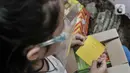 Seorang anak membuka boks donasi ponsel yang diberikan oleh Komunitas #WartawanLintasMedia saat acara #PonselPintarUntukPelajar di Jakarta, Minggu (9/8/2020). (merdeka.com/Iqbal S. Nugroho)