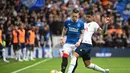 Gelandang Rangers, Ryan Kent (kiri) berebut bola dengan bek Tottenham Hotspur, Cristian Romero dalam pertandingan persahabatan di Stadion Ibrox di Glasgow (23/7/2022). Tottenham menang tipis atas Rangers 2-1. (AFP Photo/Andy Buchanan)