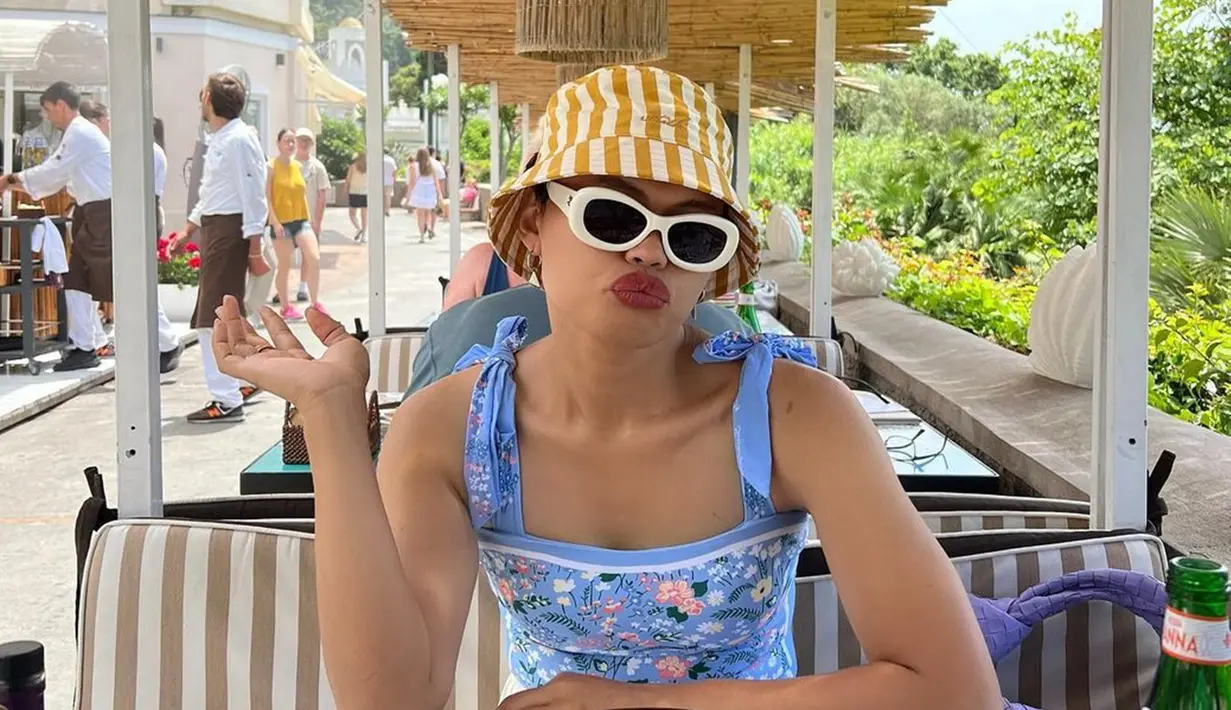 Kenakan bucket hat stripes kuning warnanya kontras dengan baju biru yang dikenakannya, penampilan Wanda Hara tetap kece. Kacamata hitam gagang putih mendukung penampilannya jadi makin menarik. Lipstik merah yang dipoles di bibirnya membuat Wanda Hara makin memesona. Selalu stylish, penampilan fashion stylist ternama ini kerap curi perhatian netizen. (Liputan6.com/IG/@wanda_haraa)
