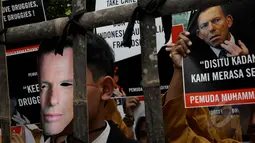 Massa mengenakan topeng  PM Australia Tony Abbot saat menggelar aksi demo di depan Kedubes Australia, Jakarta, Rabu (25/2/2015). Massa memprotes pernyataan Tony Abbott terkait dua terpidana mati Andrew Chan dan Myuran Sukumaran. (Liputan6.com/JohanTallo)