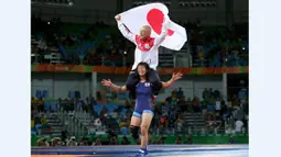  Pegulat putri Jepang, Risako Kawai, merayakan kemenangan bersama sang pelatih setelah meraih medali emas gulat kelas bebas 63 kg Olimpiade Rio 2016 di Carioca Arena 2, Rio de Janeiro, Brasil, (18/8/2016). (Reuters/Toru Hanai)