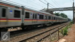 Kereta melintas di samping proyek pembangunan JPO di Stasiun Pasar Minggu Baru, Jakarta (30/11). Proyek yang menghabiskan dana APBD sekitar Rp 800 juta merupakan upaya untuk mengurangi angka kecelakaan di lintasan kereta api. (Liputan6.com/Yoppy Renato)