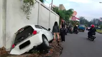 Seorang wanita berusia 18 tahun mengalami kecelakaan, di mana mobilnya masuk ke dalam saluran air di Jalan Mayor Oking, Cibinong, Bogor, Sabtu (21/5/2022). (Achmad Sudarno/Liputan6.com)