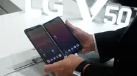 Pengunjung memeriksa smartphone LG V50 ThinQ 5G dalam gelaran Mobile World Congress (MWC) 2019 di Barcelona, Spanyol, Rabu (27/2). Perusahaan fokus pada layar yang dapat dilipat dan pengenalan jaringan nirkabel 5G.(Pau Barrena/AFP)