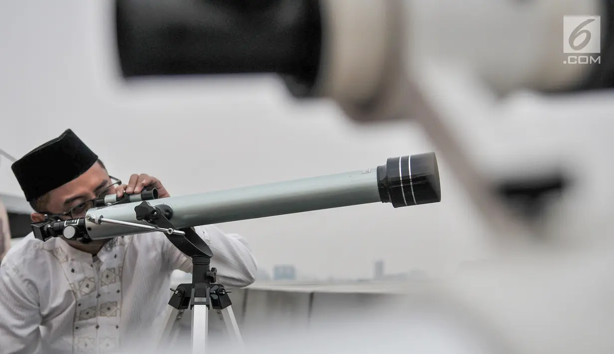 Tim hisab rukyat Kanwil Kemenag DKI Jakarta memantau hilal menggunakan teleskop di atap Gedung Kanwil Kemenag DKI Jakarta, Senin (03/6/2019). Posisi hilal sore ini menurut tim hisab adalah di 0,07 derajat di bawah ufuk, dan tidak terlihat hilal. (merdeka.com/Iqbal S Nugroho)