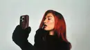 Hailey tampil sebagai karakter utama, mengenakan celana kargo hijau longgar, ikat pinggang coklat, dan turtleneck hitam. Ia mengenakan sarung tangan hitam besar yang menyerupai kartun, dan meniru karakter tersebut dengan wig merah menyala. [@justinbieber/@haileybieber].