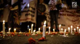 assa dari Solidaritas Merah Putih menggelar aksi lilin dan tabur bunga di lokasi bom Terminal Kampung Melayu, Jakarta, Kamis (25/5). Aksi tersebut sebagai bentuk malam solidaritas duka untuk bom Kampung Melayu.(Liputan6.com/Faizal Fanani)